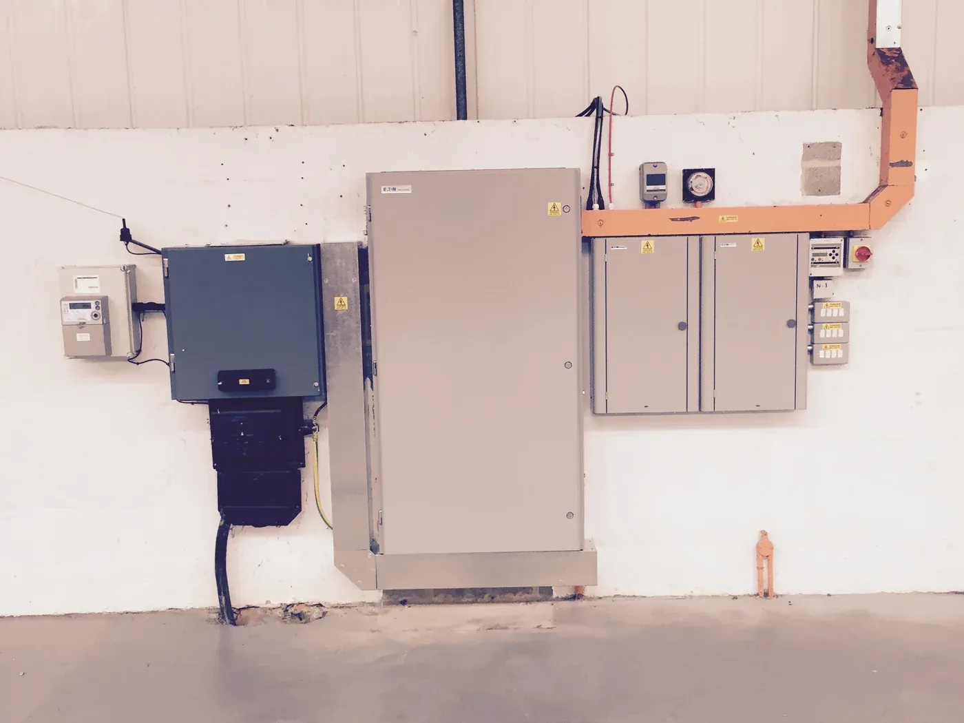 Distribution board, sub-boards and containment installed on a commercial unit wall in Northamptonshire